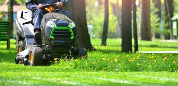 person using sit on lawn mower